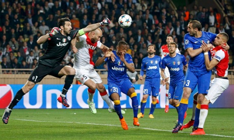 Juventus goalkeeper Gianluigi Buffon punches clear from Monaco's Aymen Abdennou.