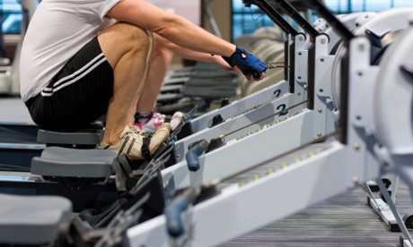 Man working out on rowing machine.