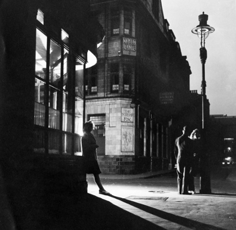A woman and a couple outside the Intrepid Fox pub in Soho, London, in 1947.