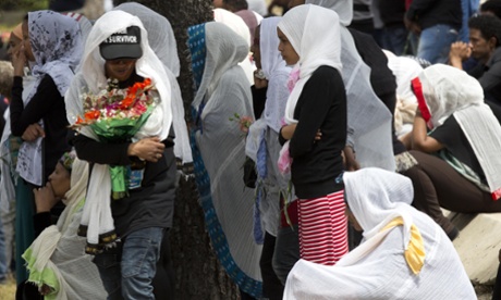 Women cry as the coffin of one of the 24 migrants drowned while trying to reach the Southern coasts of Italy, is buried in L'Addolorata cemetery, in the outskirts of Valletta, Malta.