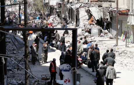 01 Apr 2014, Damascus, Syria --- Residents wait to receive food aid distributed by the Al-Wafaa campaign at the Palestinian refugee camp of Yarmouk, south of Damascus April 1, 2014. 