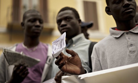 Migrants in Rome hold paper boats at a demonstration this week over Europe's meagre quota of humanit