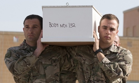 Numbered coffins are carried during a funeral service in Malta for 24 migrants drowned while trying to reach Italy.