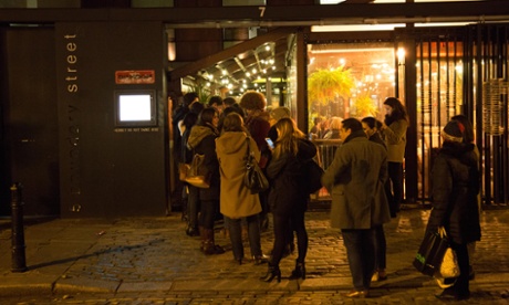 A queue of diners outside Dishoom in Shoreditch, London