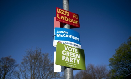 General election campaign posters for the Labour party, the Conservative Party and the Green Party are attached to a lamp post in the 'Colne Valley' constituency in Slaithwaite, northern England, on April 21, 2015