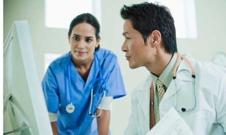 Doctors looking at computer
