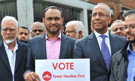 The then mayor of Tower Hamlets, Lutfur Rahman, centre right, stands next to his supporters during a campaign rally last May. That mayoral election will be rerun after Thursday's ruling.