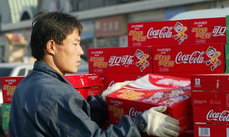 man unloading coca-cola packets 