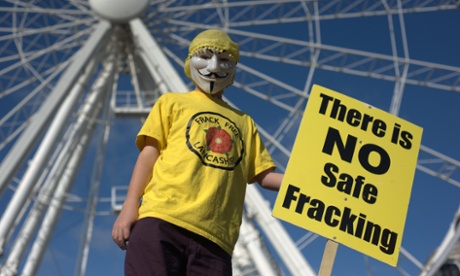A protester in front of the big wheel in Manchester