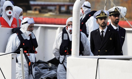 Italian coast guards prepare to disembark with some of the bodies of the 800 migrants who died in the Mediterranean last weekend.