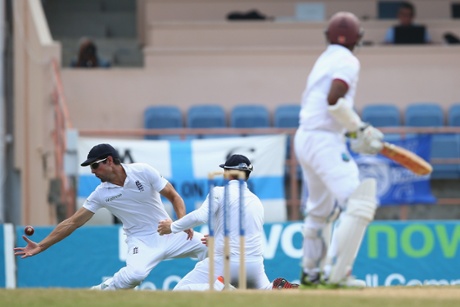 Alastair Cook, left, of England takes a catch at first slip to claim the wicket of Shivnarine Chanderpaul.
