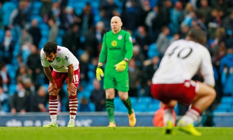 The final whistle brings dejection for the Villa players.