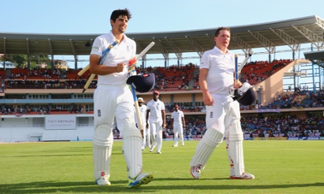 Alastair Cook, left, and Gary Ballance, right, celebrate as they leave the pitch following Englalnds' victory by nine wickets over West Indies.