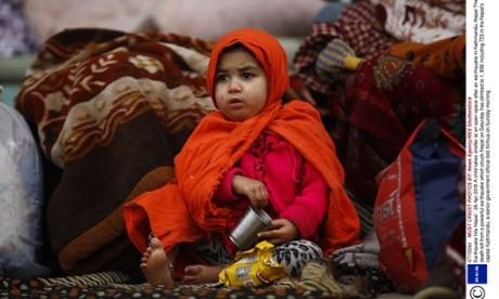 A child takes shelter at an open space after an earthquake in Nepal.