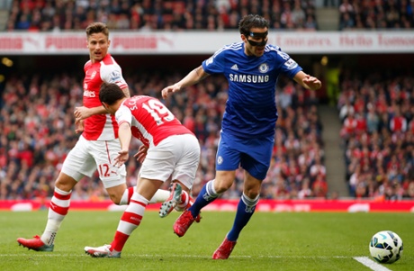 Cesc Fabregas goes down in the penalty area after this challenge from Santi Cazorla