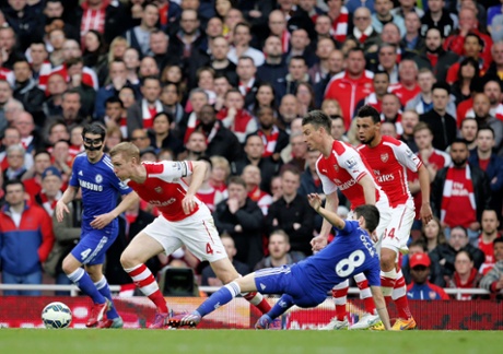 Per Mertesacker pulls away from a Oscar tackle.