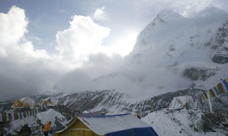A small avalanche on Pumori as seen from Everest base camp on Sunday. Aftershocks have sent avalanches streaming around the base camps.