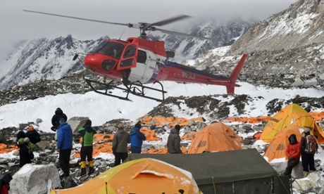 A rescue helicopter prepares to land and airlift the injured from Everest Base Camp.