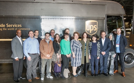 winners in front of ups truck