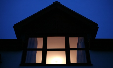 A bedroom with a light on.