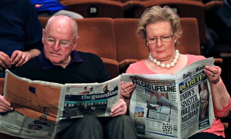 Snooker spectators reading the newspapers before day five of the world championships in Sheffield