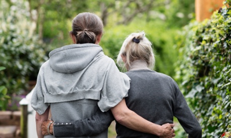 two generations women walking in garden together