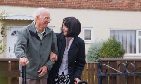 volunteer helping an elderly man with his shopping