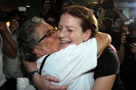 Greenpeace activist Ana Paula Maciel Alminhana is greeted by her grandmother as she arrives home in Brazil after two months' detention in Russia.