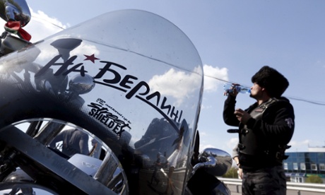 A member of Night Wolves participating in the group ride to commemorate the 70th anniversary of the Soviet victory over Nazi Germany. The sign reads 'On Berlin!' 