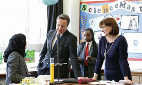 David Cameron and education secretary Nicky Morgan taking part in science lesson. Neither Labour nor the Conservatives have pledged to do as much as retain the current level of funding.