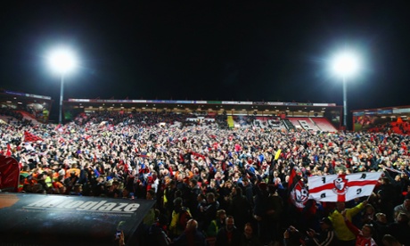 Fans invade the pitch after victory and almost certain promotion.