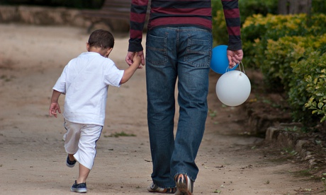 little boy holding fathers hand