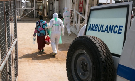 A health worker with an Ebola patient at the Kerry town treatment centre outside Freetown last December.