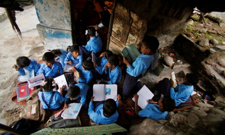 Indian children study at an open air school at a makeshift shelter during in Jammu.