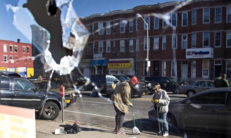 Two women sweeping up the streets in Baltimore