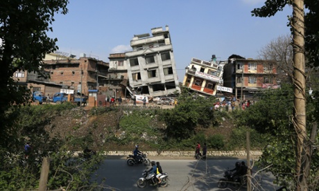 Damaged buildings lean to their sides in Kathmandu, Nepal, Monday, April 27, 2015. A strong magnitude 7.8 earthquake shook Nepal's capital and the densely populated Kathmandu Valley on Saturday, causing extensive damage with toppled walls and collapsed buildings. 