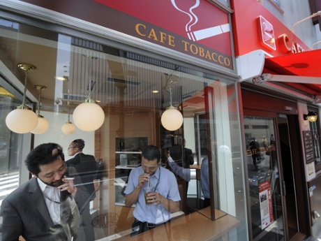 People smoking and drinking in a 'Cafe Tobacco' shop in Tokyo's Shinbashi district.
