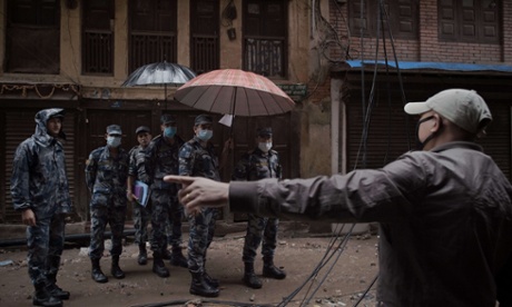 Nepalese police talk with a resident in Kathmandu.