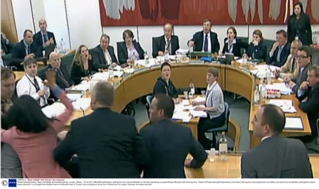 Wendi Deng Murdoch striking the man (Jonnie Marbles on the left) attempting to assault Rupert Murdoch with shaving foam.