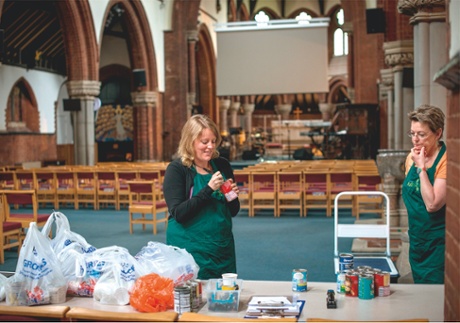Food bank volunteers sort goods arriving from donors at St Mark’s Church in Clapham, south London