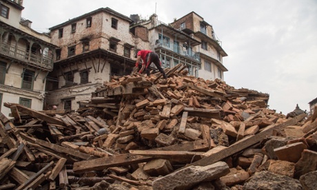 A volunteer clears the remains of a collapsed temple at Basantapur Durbar Square.