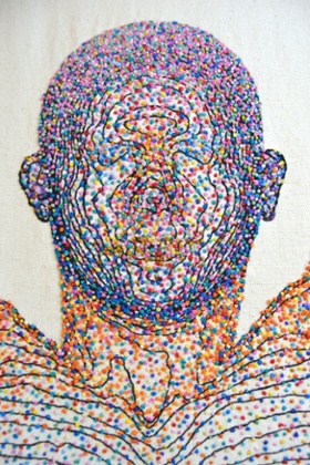 Symbiosis by Rebecca D. Harris. An embroidered body map of microbes.
