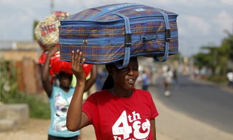 Women carry their belongings as they flee in fear of recent clashes between riot-policemen and protesters against the ruling CNDD-FDD party's decision to allow President Pierre Nkurunziza to run for a third five-year term in office, in Bujumbura, Burundi April 29, 2015. A top U.S. diplomat was heading to Burundi on Wednesday, seeking to halt escalating unrest triggered by President Pierre Nkurunziza's decision to seek a third term in office, a move protesters say is unconstitutional.