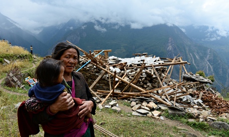 TOPSHOTS A mother carries her son as she