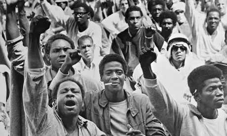Inmates at the Attica correctional cacility give the black power salute