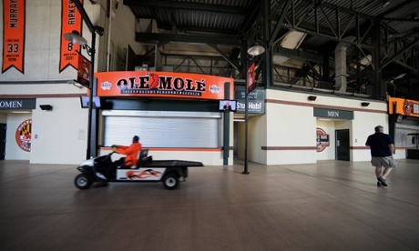 A Baltimore Orioles employee drives through the usually busy stadium concourse.