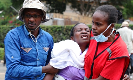 Kenya Red Cross staff help a family member of one of the victims of Thursday's attack.