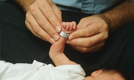 Maternity ward putting a name tag on new born's wrist