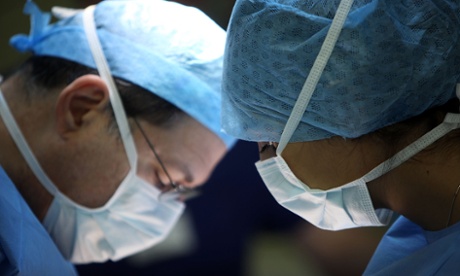 A surgeon and his theatre team perform key hole surgery