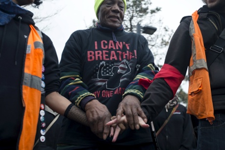 Marshall Cooper Jr. holds hands with fellow demonstrators in Boston on Wednesday